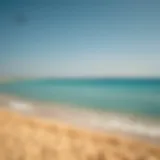 A serene view of Hudayriat Public Beach showcasing the golden sands and turquoise waters