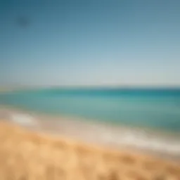 A serene view of Hudayriat Public Beach showcasing the golden sands and turquoise waters
